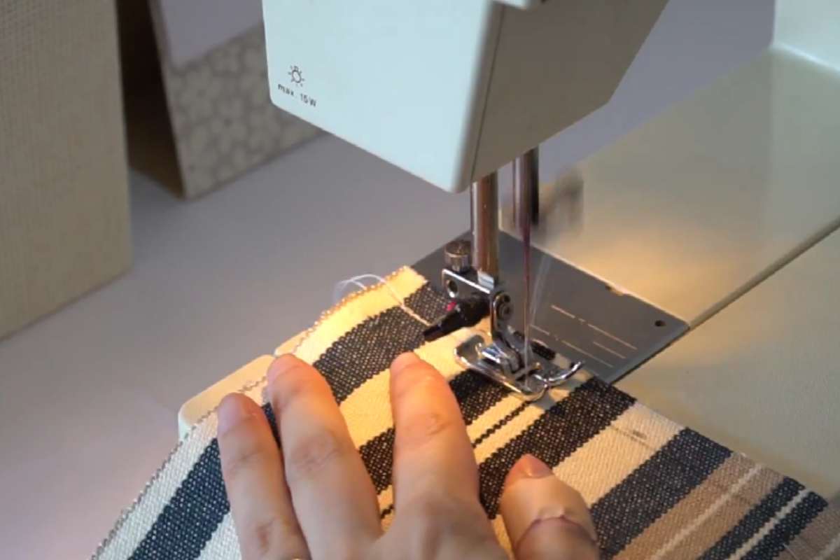 mani rattoppano federe con una macchina da cucire